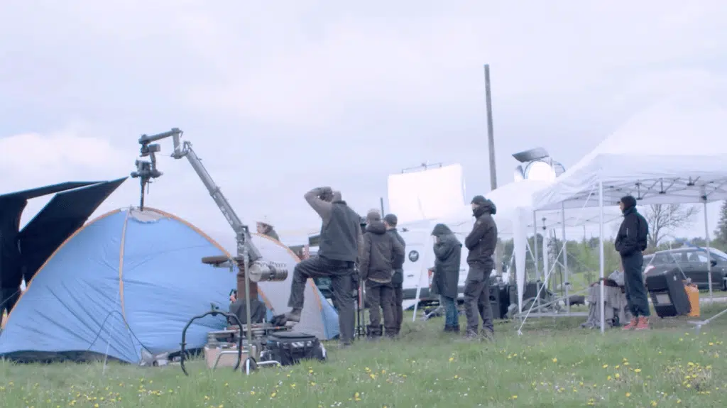 Tents in a film with a film crew in activity
